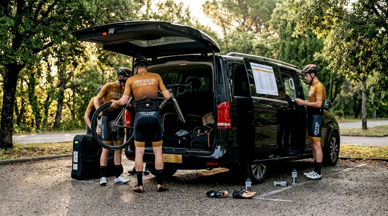 Cyclists unloading bikes from luxury van at dawn