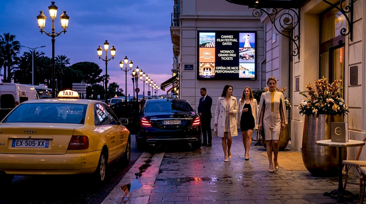 Taxi and VTC vehicles parked outside hotel