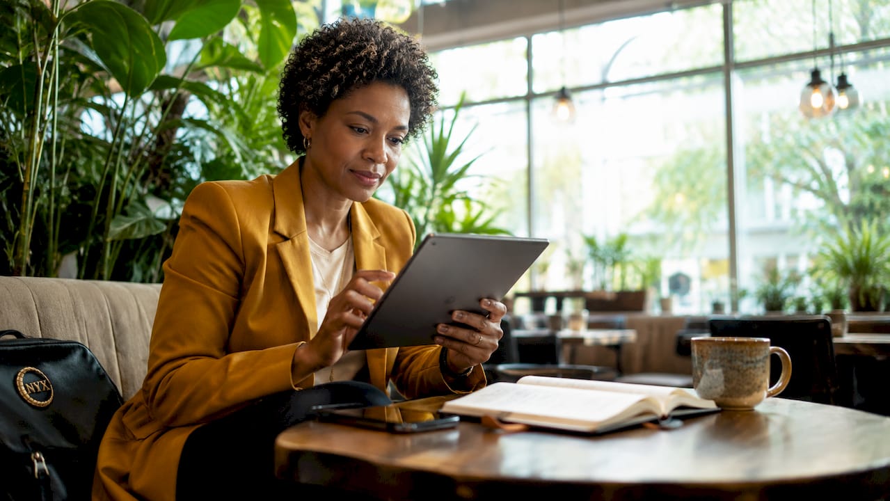 Woman booking point-to-point transfer on tablet