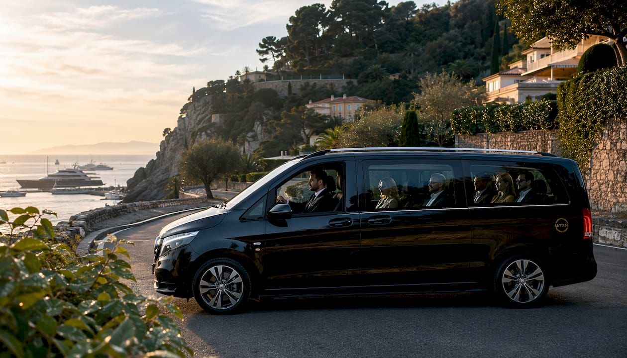 Mercedes-Benz van chauffeured corporate group driving on scenic coastal road near Antibes
