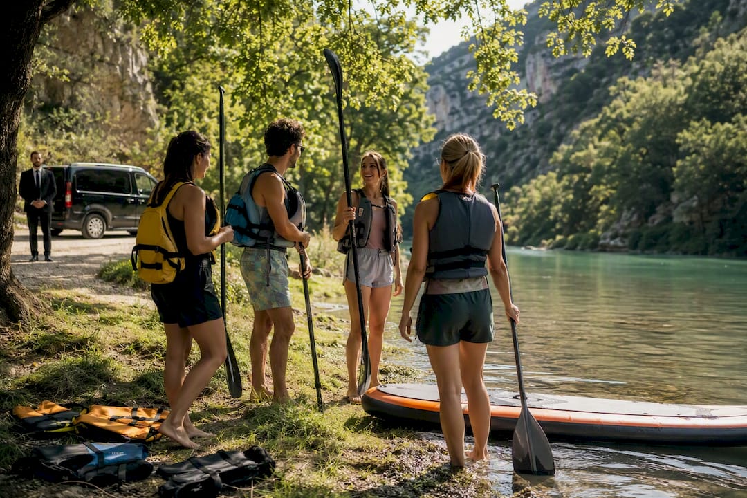 Mercedes van and paddlers preparing on lake Sainte-Croix for water activities near Gorges du Verdon