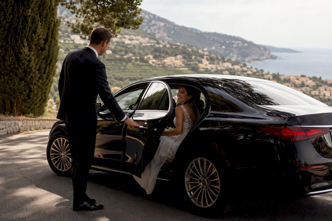Wedding chauffeur Mercedes sedan door opening coastal road Nice French Riviera