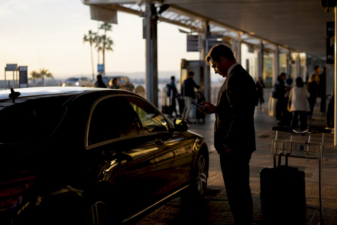 Mercedes chauffeur checking flight status near Nice Airport
