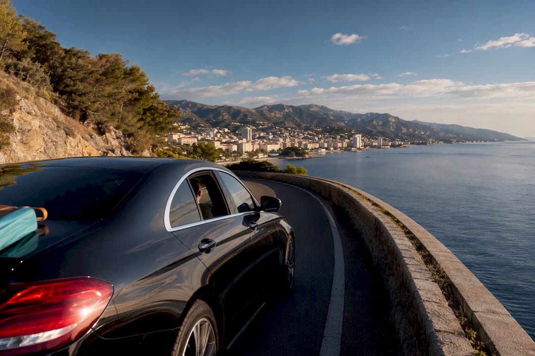 Private chauffeur Mercedes sedan on Nice to Monaco coastal transfer along the French Riviera