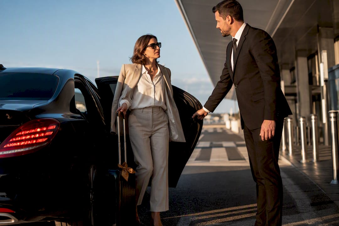 Mercedes-Benz sedan greeting a traveler for a private airport transfer at Nice Côte d’Azur Airport.