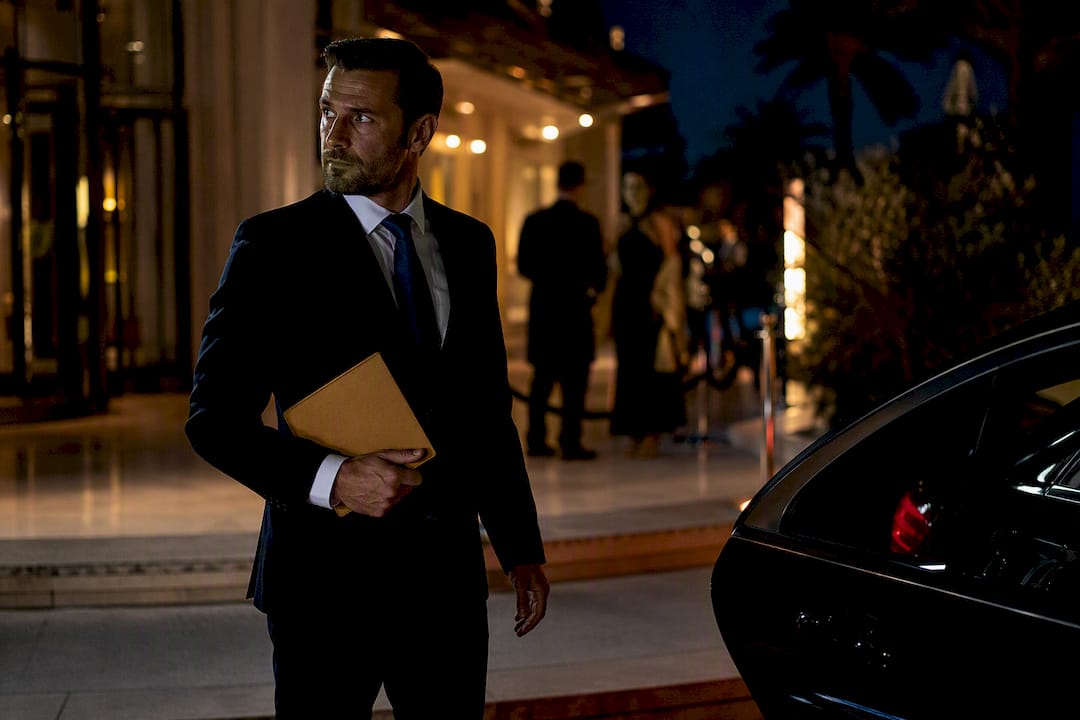 Private chauffeur Mercedes sedan waiting for a night transfer at Cannes event venue