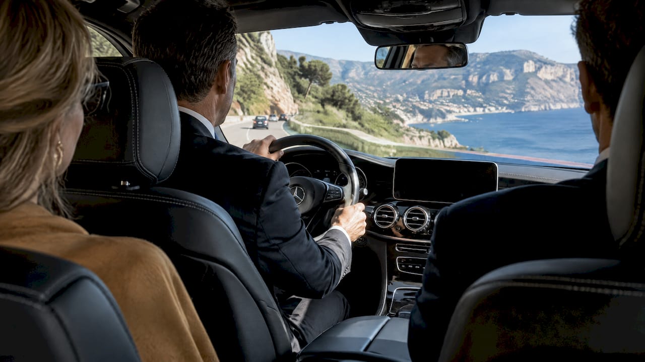 Mercedes-Benz sedan carrying event guests on a chauffeur-driven itinerary near Cap d’Ail, French Riviera.