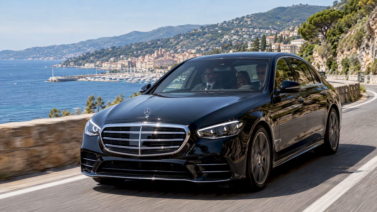 Mercedes-Benz sedan on a private chauffeur transfer from Nice toward Sanremo along the Ligurian coast.