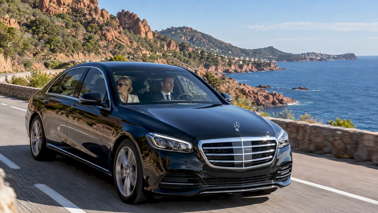 Mercedes-Benz sedan carrying a private chauffeur along the Corniche d'Or in the Estérel, France.