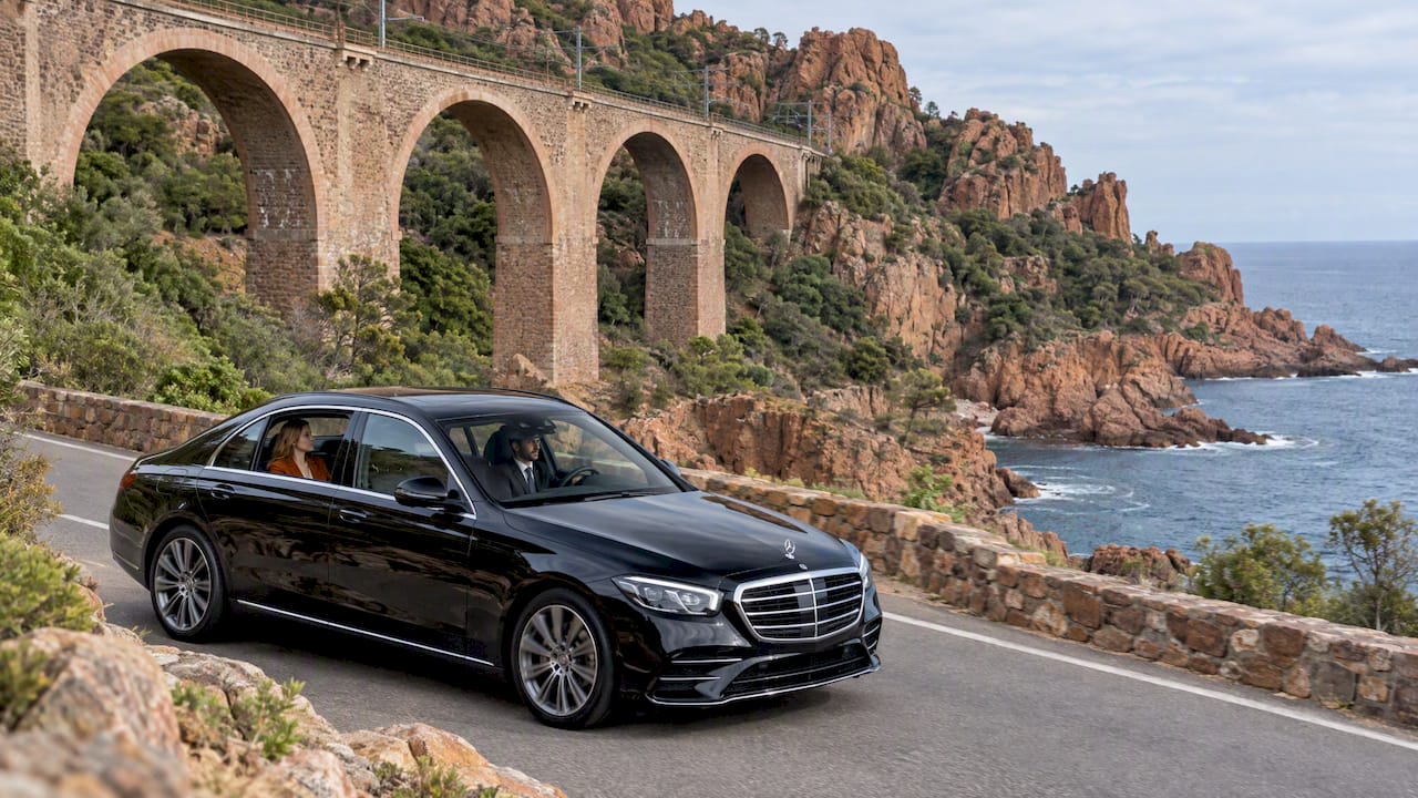 Mercedes-Benz sedan passing Anthéor railway viaduct on a private chauffeur drive along the Corniche d'Or.