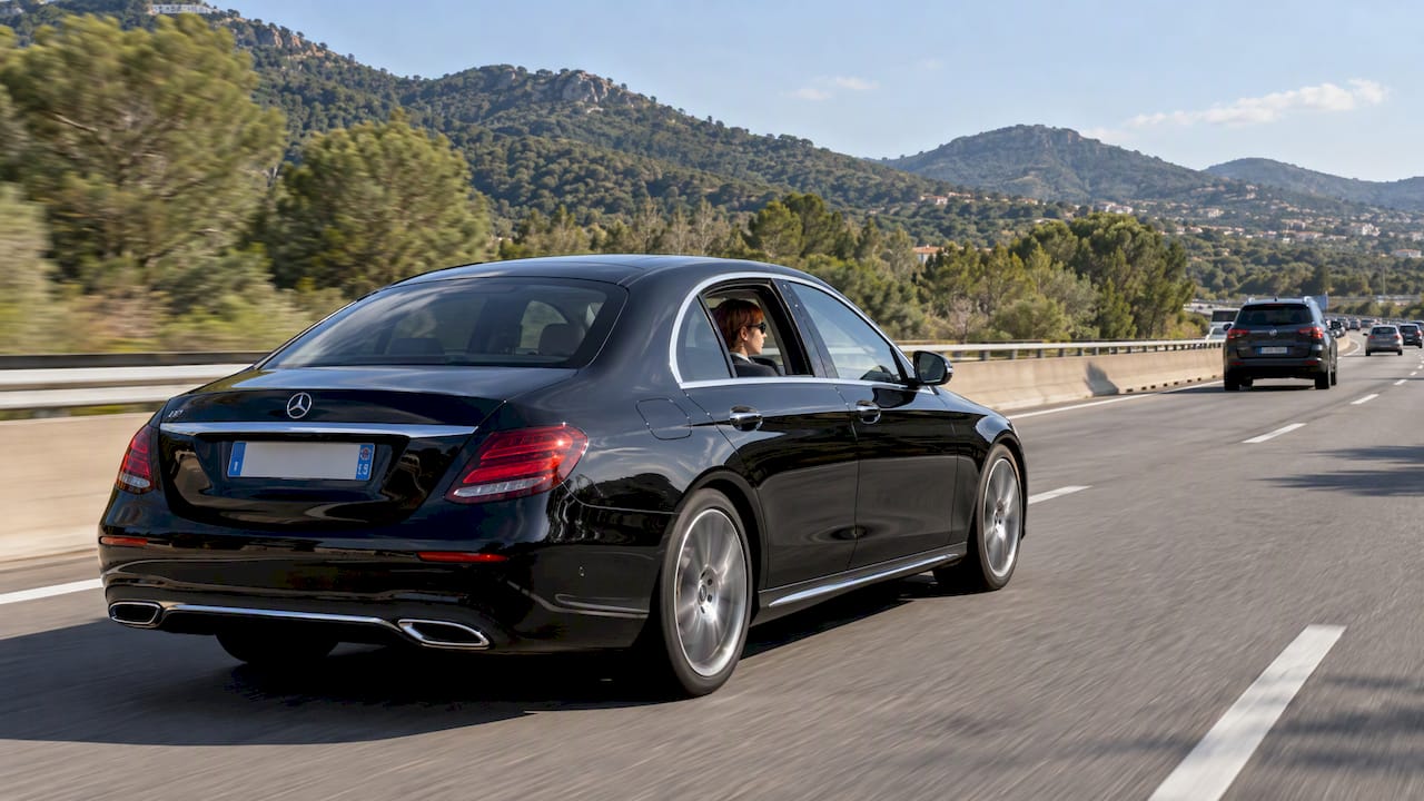 Mercedes-Benz sedan on a chauffeur transfer toward Saint-Tropez via the A8 motorway from Nice.
