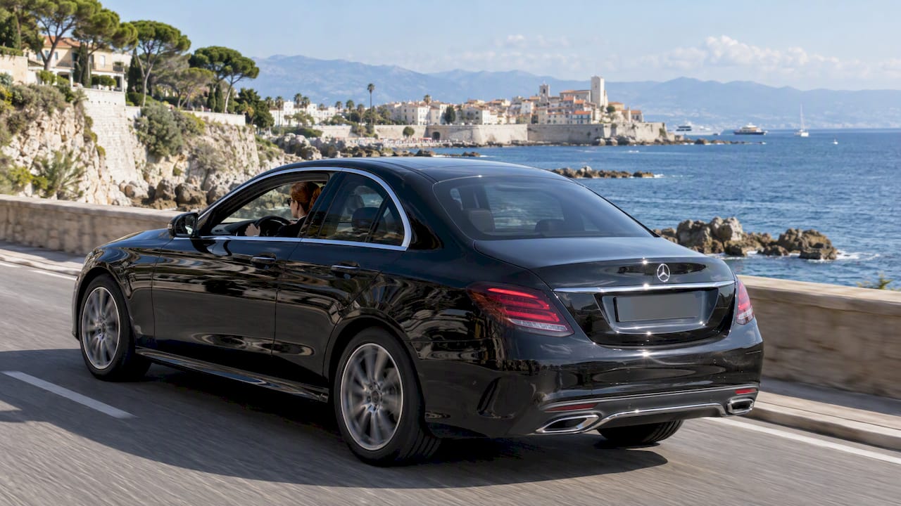 Mercedes-Benz private chauffeur driving along the Antibes coast before a Provence excursion from the Riviera.