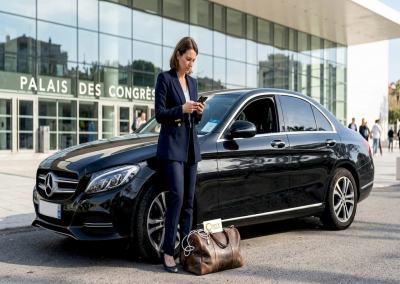 Businesswoman with luxury car outside Palais
